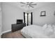 Neutral bedroom with a king bed, dresser, dark window treatments, and a modern ceiling fan at 10712 Pontofino Cir, Trinity, FL 34655