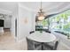 Breakfast nook boasts backyard views, stylish chandelier, gray walls, and seamless access to the rest of the home at 10712 Pontofino Cir, Trinity, FL 34655