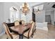 Elegant dining room with a chandelier and windows with plantation shutters for natural light at 10712 Pontofino Cir, Trinity, FL 34655