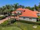 Beautiful home featuring a clay tile roof, lush landscaping, and a brick paver driveway at 10712 Pontofino Cir, Trinity, FL 34655
