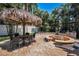 Outdoor dining area featuring a large sun shade, fire pit and built-in grill, perfect for enjoying resort-style living at 10712 Pontofino Cir, Trinity, FL 34655
