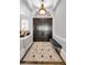 Elegant foyer featuring a soaring ceiling, custom lighting fixture and a beautiful tiled floor at 10712 Pontofino Cir, Trinity, FL 34655