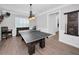 A versatile game room with ping pong table, custom lighting, and hardwood flooring offering entertainment at 10712 Pontofino Cir, Trinity, FL 34655
