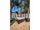 A tranquil outdoor oasis featuring a hammock among palm trees, offering a peaceful spot to relax in a serene setting at 10712 Pontofino Cir, Trinity, FL 34655