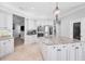Spacious kitchen features a large island with granite countertops, stainless steel appliances, and custom white cabinetry at 10712 Pontofino Cir, Trinity, FL 34655