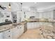 Gourmet kitchen features granite countertops, a center island, custom cabinets, and stainless steel appliances at 10712 Pontofino Cir, Trinity, FL 34655