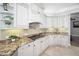 Stylish kitchen features granite countertops, custom cabinetry, and modern appliances at 10712 Pontofino Cir, Trinity, FL 34655