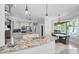 Bright kitchen boasts granite countertops, stainless steel appliances, custom cabinetry, and adjacent breakfast nook at 10712 Pontofino Cir, Trinity, FL 34655