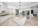 Spacious kitchen featuring granite countertops, white cabinetry, stainless steel appliances, and a functional island at 10712 Pontofino Cir, Trinity, FL 34655