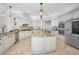 Gourmet kitchen with granite countertops, a center island, stainless steel appliances, and custom white cabinetry at 10712 Pontofino Cir, Trinity, FL 34655