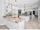 Gourmet kitchen featuring custom cabinets, granite countertops, stainless steel appliances, and a center island at 10712 Pontofino Cir, Trinity, FL 34655
