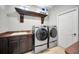 Laundry room with modern appliances, sink and counter space, and ample storage at 10712 Pontofino Cir, Trinity, FL 34655