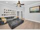 Open living room with light hardwood flooring, a gray sofa, and a dark marble coffee table at 10712 Pontofino Cir, Trinity, FL 34655