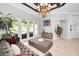 Bright living room with coffered ceilings, chandelier, and French doors leading to the outdoor area at 10712 Pontofino Cir, Trinity, FL 34655