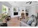 Living room features a fireplace, mounted television, and a stylish sofa with comfortable throw pillows and natural light at 10712 Pontofino Cir, Trinity, FL 34655