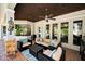Cozy outdoor living area with stylish seating, outdoor kitchen, and lush tropical views at 10712 Pontofino Cir, Trinity, FL 34655