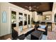 Relaxing outdoor living space with comfortable seating, ceiling fan, and outdoor kitchen at 10712 Pontofino Cir, Trinity, FL 34655