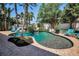 Beautiful kidney-shaped pool with brick pavers, lush tropical landscaping, and inviting lounge chairs for relaxing poolside at 10712 Pontofino Cir, Trinity, FL 34655