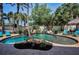 Beautiful pool with lush tropical landscaping and a relaxing hammock create a serene backyard oasis at 10712 Pontofino Cir, Trinity, FL 34655
