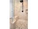 A neutral toned tile shower with glass enclosure, bench seating and a rainfall shower head at 10712 Pontofino Cir, Trinity, FL 34655