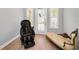 Relaxing sitting area with a massage chair, chaise lounge, and natural light from shuttered windows at 10712 Pontofino Cir, Trinity, FL 34655