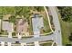 This aerial view showcases a well-maintained property with lush greenery and a sparkling screened-in pool at 11253 Avalon Way, Spring Hill, FL 34609
