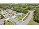 Areal view of a well maintained house surrounded by lush, mature trees and adjacent to a road at 11253 Avalon Way, Spring Hill, FL 34609