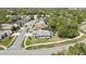 This aerial view highlights the home's location in a serene neighborhood with mature trees and landscaping at 11253 Avalon Way, Spring Hill, FL 34609