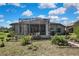 Backyard view featuring the house and screened in porch at 11253 Avalon Way, Spring Hill, FL 34609