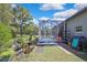 Well maintained backyard with large screened lanai and lush landscaping at 11253 Avalon Way, Spring Hill, FL 34609