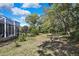 Lush backyard featuring a screened in porch at 11253 Avalon Way, Spring Hill, FL 34609