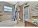 Bright bathroom with granite vanity, shower/tub combo, and outdoor access at 11253 Avalon Way, Spring Hill, FL 34609