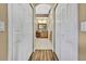 Hallway view into a luxurious bathroom with double closets, double vanity and ornate finishes at 11253 Avalon Way, Spring Hill, FL 34609
