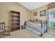 Cozy bedroom featuring a daybed, rocking chair, and bookshelf at 11253 Avalon Way, Spring Hill, FL 34609