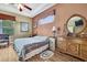 Cozy bedroom featuring a wooden dresser with a circular mirror, warm colors, and natural light at 11253 Avalon Way, Spring Hill, FL 34609