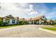The community center's exterior features elegant architecture, well-manicured landscaping, and a welcoming porte-cochere at 11253 Avalon Way, Spring Hill, FL 34609