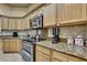 Well-equipped kitchen with granite counters and stainless steel appliances at 11253 Avalon Way, Spring Hill, FL 34609