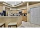 Bright kitchen featuring tile floors, wood cabinets, and granite countertops at 11253 Avalon Way, Spring Hill, FL 34609