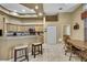 Open kitchen with breakfast bar, tile floors, and wood cabinets at 11253 Avalon Way, Spring Hill, FL 34609