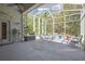 Spacious screened lanai with ceiling fan, outdoor seating, and view of backyard at 11253 Avalon Way, Spring Hill, FL 34609