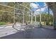 Covered lanai with seating and view of trees at 11253 Avalon Way, Spring Hill, FL 34609
