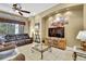 Open-concept living room featuring tile floors, ceiling fan, and neutral-toned walls at 11253 Avalon Way, Spring Hill, FL 34609
