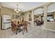 Open-concept living room featuring tile floors, ceiling fan, and neutral-toned walls at 11253 Avalon Way, Spring Hill, FL 34609