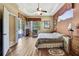 Comfortable main bedroom with wood floors, tray ceiling, and natural light at 11253 Avalon Way, Spring Hill, FL 34609