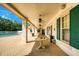 Inviting patio area offering a tranquil space for relaxation, complemented by stylish seating and elegant architectural details at 11253 Avalon Way, Spring Hill, FL 34609
