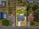 Aerial view of a home with large back yard, bordered by a white fence, and a driveway leading to the street at 11630 Pasadena Rd, Dade City, FL 33525