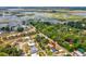 An aerial view of the property showcases the neighborhood, proximity to local lake, and mature trees at 11630 Pasadena Rd, Dade City, FL 33525