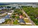 An aerial view of the property showcases the neighborhood, manicured yard, and mature trees at 11630 Pasadena Rd, Dade City, FL 33525