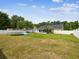 Spacious fenced backyard with a screened patio, trampoline and inflatable pool at 11630 Pasadena Rd, Dade City, FL 33525