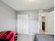 Cozy bedroom featuring a double door closet and neutral gray walls at 11630 Pasadena Rd, Dade City, FL 33525